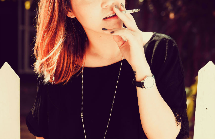 woman holding a cigarette and smoking effects on hair